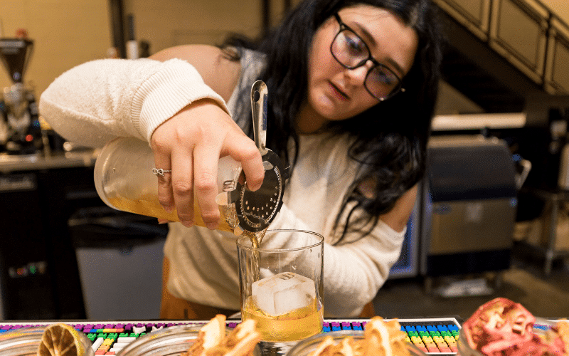 Rivka Alvial pouring a drink at miXt Food Hall